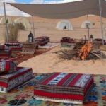 Découvrez l'Émerveillement du Sud Tunisien Voyager dans le sud de la Tunisie est une expérience inoubliable. Loin de l'agitation des villes, cette région offre un véritable écrin de beauté naturelle, où le Sahara déploie ses vastes étendues de dunes dorées. Les excursions et circuits désertiques sont des joyaux de cette région, offrant aux voyageurs une immersion authentique dans un paysage unique et des traditions séculaires. Excursions dans le Désert Tunisien : Une Aventure Époustouflante Les excursions dans le désert tunisien sont un appel à l'aventure et à la découverte. Les circuits bien planifiés vous conduisent à travers des oasis cachées, des villages traditionnels berbères et des paysages désertiques à couper le souffle. Imaginez-vous conduisant à travers les dunes, avec pour seule compagnie le sable scintillant sous le soleil éclatant. Les Richesses Culturelles du Sud Tunisien Au-delà des paysages à couper le souffle, le sud de la Tunisie regorge également d'une richesse culturelle incroyable. Les rencontres avec les habitants, les visites de marchés locaux animés et les traditions ancestrales partagées par les habitants sont autant d'expériences enrichissantes qui donnent une dimension humaine à votre voyage. Circuit Désertique : Une Plongée dans l'Authenticité Tunisienne Un circuit désertique dans le Sahara tunisien offre une immersion totale dans la vie nomade, permettant de découvrir les coutumes, les cuisines locales et l'hospitalité exceptionnelle des habitants. La nuit tombée, sous un ciel étoilé spectaculaire, les camps traditionnels berbères vous accueillent pour des moments uniques de partage et de contemplation. Pourquoi Choisir notre Excursion & Circuit Désert en Tunisie ? Notre offre d'excursion et de circuit désertique en Tunisie est conçue pour offrir une expérience authentique et immersive. Avec des guides locaux passionnés et expérimentés, nous vous garantissons un voyage mémorable, où chaque moment est une découverte nouvelle et fascinante. Que vous souhaitiez explorer les majestueuses dunes du Sahara, découvrir la vie nomade ou vous imprégner de la culture berbère, notre circuit désert en Tunisie est une porte ouverte vers l'aventure, la culture et la beauté brute du désert. Laissez-vous séduire par cette expérience unique au cœur du Sud Tunisien, où le désert dévoile ses mystères et où chaque grain de sable raconte une histoire.