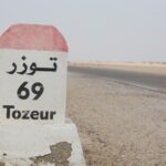 Le Sud tunisien est un lieu où le temps semble s'arrêter, offrant à ses visiteurs une expérience unique entre dunes de sable, villages berbères et oasis verdoyantes. Si vous êtes à la recherche d'une aventure authentique, le circuit "Trois Jours Deux Nuits" que nous proposons chez www.sudtunisie.com est l'occasion parfaite pour explorer cette région fascinante et vivre une immersion totale au cœur du désert. Alliant découverte, confort et dépaysement, ce séjour est conçu pour vous faire profiter au maximum des merveilles naturelles et culturelles du Sud tunisien. Jour 1 : Cap sur le désert et immersion à Douz Votre aventure commence par la découverte de Douz, souvent appelée la "porte du désert". Située au bord du Grand Erg Oriental, cette petite ville est le point de départ idéal pour explorer le Sahara tunisien. Dès votre arrivée, vous ressentirez l'atmosphère envoûtante du désert, avec ses vastes étendues de sable à perte de vue et ses dromadaires paresseusement couchés à l’ombre. Balade en chameau à travers les dunes L'une des meilleures façons de vivre pleinement l'expérience du désert est de partir en balade à dos de chameau. Accompagné de nos guides expérimentés, vous traverserez les dunes dorées de Douz, une expérience à la fois paisible et dépaysante. Le rythme lent du chameau, le silence du désert et la douceur du vent sur votre visage vous offriront une véritable parenthèse hors du temps. Dîner sous les étoiles À la tombée de la nuit, vous serez accueilli dans un campement traditionnel où vous pourrez déguster un dîner typique tunisien préparé avec des produits locaux. Sous le ciel étoilé, loin de toute pollution lumineuse, vous vivrez un moment magique, bercé par le chant du désert. La nuit se passe dans une tente confortable, vous permettant de vous reposer tout en restant en totale immersion dans le désert. Jour 2 : Exploration de Ksar Ghilane et Bains dans les Sources Chaudes Le deuxième jour de votre excursion vous emmène à Ksar Ghilane, une oasis en plein cœur du désert. Après un petit-déjeuner copieux au campement, vous prendrez la route en direction de cette oasis emblématique, connue pour ses sources d'eau chaude naturelles et son paysage idyllique. Bain relaxant dans les sources naturelles L'une des expériences incontournables à Ksar Ghilane est de plonger dans ses sources thermales naturelles. Ce bain relaxant au milieu du désert vous offrira une sensation de bien-être incomparable, avec l'eau chaude apaisant vos muscles après une journée d'exploration. L'oasis, avec ses palmiers et son cadre paisible, est l'endroit parfait pour se ressourcer. Balade en quad dans les dunes Pour les amateurs d'aventure, Ksar Ghilane propose aussi des excursions en quad à travers les dunes. C’est l’occasion idéale de vivre une montée d'adrénaline tout en explorant le désert sous un autre angle. Vous pourrez découvrir des paysages désertiques à couper le souffle et peut-être même apercevoir quelques vestiges historiques, comme l'ancien fort romain situé non loin de l'oasis. Jour 3 : Visite de Tataouine et Découverte des Ksour Le dernier jour de votre circuit vous emmène à la découverte de Tataouine, une ville riche en histoire et en culture, rendue célèbre par ses ksour (pluriel de ksar). Ces anciens greniers fortifiés sont un témoignage fascinant du mode de vie des tribus berbères et vous transporteront dans un passé lointain. Visite des ksour de Ksar Ouled Soltane et Ksar Hadada Parmi les plus impressionnants ksour de la région, Ksar Ouled Soltane et Ksar Hadada se distinguent par leur architecture unique et leur état de conservation remarquable. Vous serez émerveillé par ces imposantes structures en pierre qui servaient autrefois à stocker les récoltes et à protéger les biens des tribus locales. Ces sites historiques ont également été utilisés comme décors pour des films célèbres, notamment dans la saga Star Wars, ce qui ajoutera une touche d’émerveillement à votre visite. Retour vers Douz et fin du circuit Après une journée riche en découvertes, vous reprendrez la route en direction de Douz où se termine votre circuit de trois jours. Sur le chemin du retour, vous aurez encore l'occasion de profiter des paysages uniques de cette région magnifique, avant de clôturer cette aventure inoubliable. Pourquoi choisir le circuit "Trois Jours Deux Nuits" avec www.sudtunisie.com ? 1. Une expérience authentique et personnalisée Chez www.sudtunisie.com, nous croyons que chaque voyageur mérite une expérience unique. C’est pourquoi notre circuit "Trois Jours Deux Nuits" est conçu pour vous offrir une immersion totale dans le Sud tunisien, tout en vous permettant d’explorer à votre rythme. Nos guides sont des experts locaux qui vous feront découvrir les merveilles cachées de la région tout en partageant avec vous leur passion pour cette terre fascinante. 2. Confort et aventure réunis Nous savons que l’aventure ne doit pas se faire au détriment du confort. C’est pourquoi nos campements sont soigneusement aménagés pour vous offrir un séjour confortable au cœur du désert. Des tentes spacieuses et bien équipées, des repas savoureux à base de produits locaux, et des installations modernes vous attendent pour rendre votre séjour aussi agréable que mémorable. 3. Une équipe dédiée à votre satisfaction Notre équipe est disponible à tout moment pour répondre à vos besoins et rendre votre séjour aussi agréable que possible. Que vous ayez des questions sur le déroulement du circuit ou des demandes spécifiques, nous sommes là pour vous accompagner et vous offrir une expérience sur mesure. Conclusion : Une aventure inoubliable avec www.sudtunisie.com Le circuit "Trois Jours Deux Nuits" que nous proposons chez www.sudtunisie.com est bien plus qu'une simple excursion. C'est une véritable aventure à travers les trésors naturels et culturels du Sud tunisien, une expérience qui vous marquera à jamais. Que vous soyez en quête de dépaysement, d'aventure ou simplement de détente, ce circuit est fait pour vous. Venez découvrir les merveilles du désert et laissez-vous envoûter par la beauté de cette région extraordinaire.